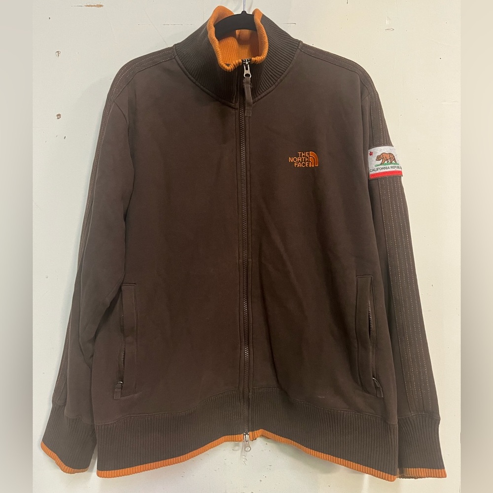 The Northface zip up jacket. Brown, orange trim, size Large (fits medium).